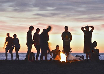 People Having Barbecue on Beach at Sunset