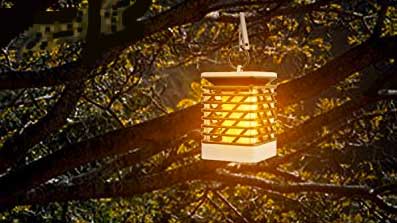 Flickering Solar Lantern Hanging from Tree Outdoors